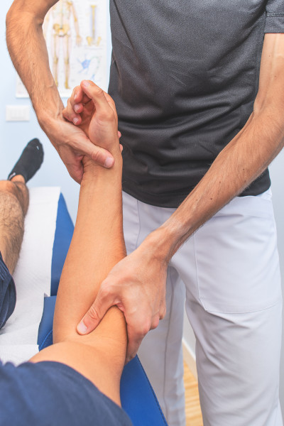 physio working on a patients sore arm